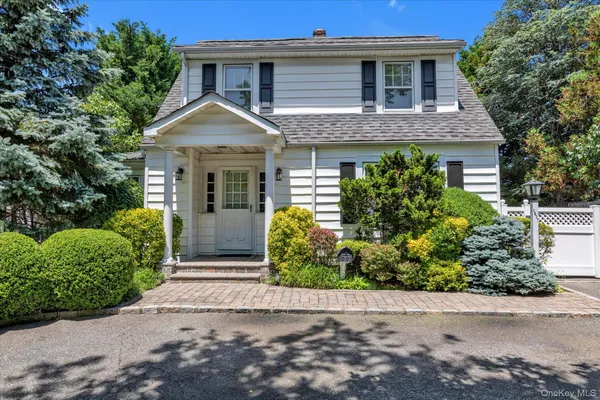 front view of house with potted plants