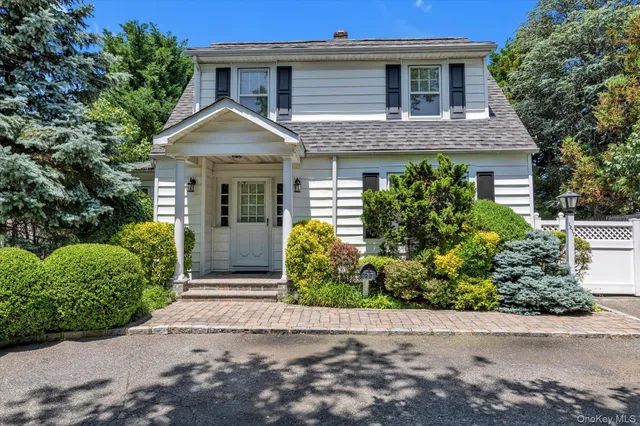 front view of house with potted plants