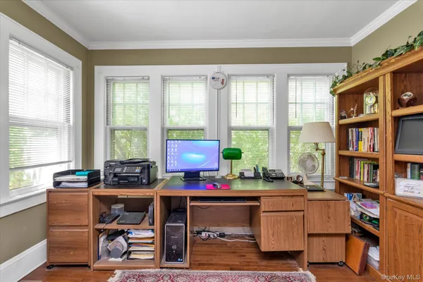 a room with furniture a bookshelf and a window