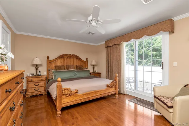 a bedroom with a bed and a large window with outer view