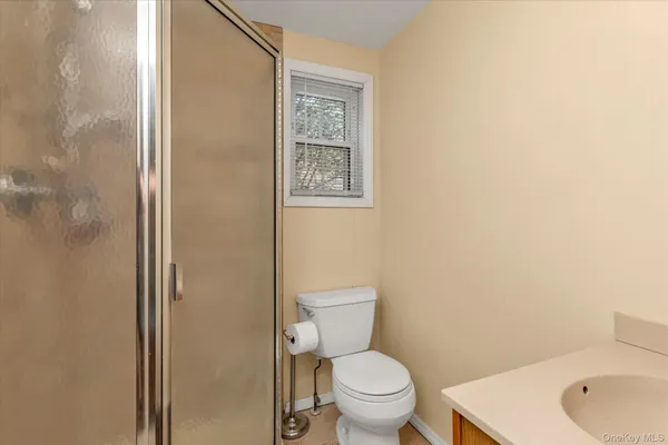 a white toilet sitting next to a bathroom sink