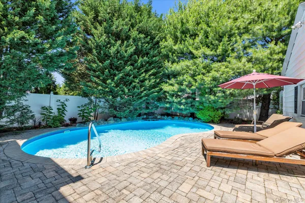 a view of a backyard with swimming pool