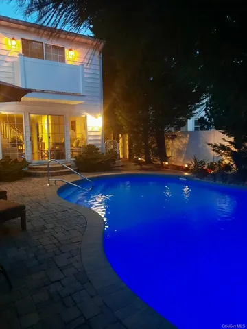 a view of swimming pool with outdoor seating