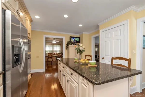 a kitchen with stainless steel appliances granite countertop a sink refrigerator and cabinets