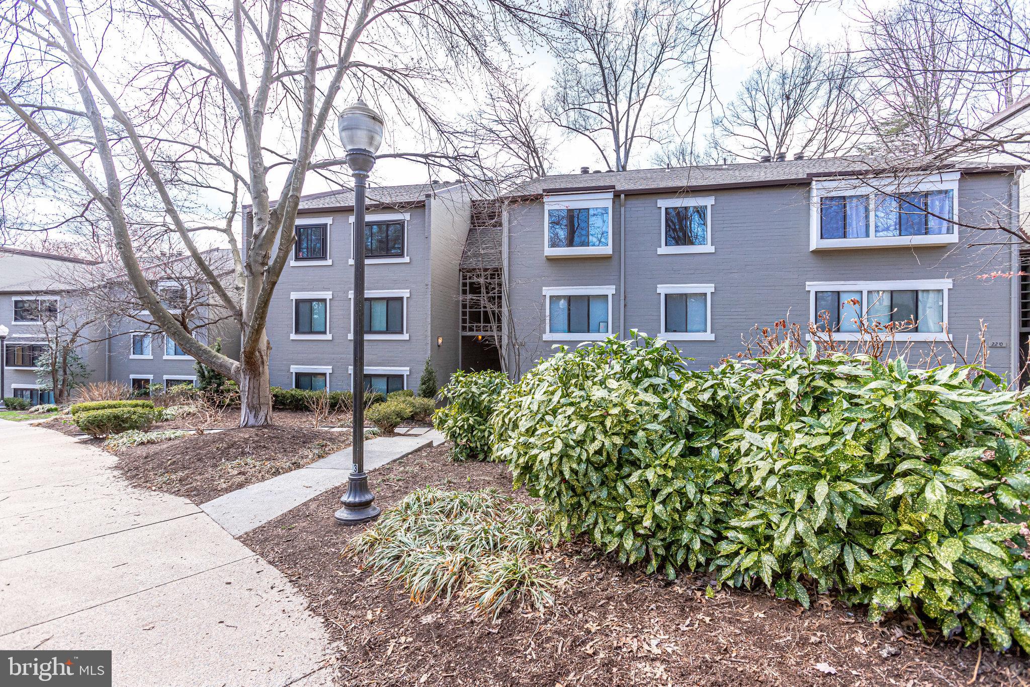 2212 Springwood Drive, Unit 206 Reston, VA 20191 - Photo 1 of 46 a front view of a house with garden