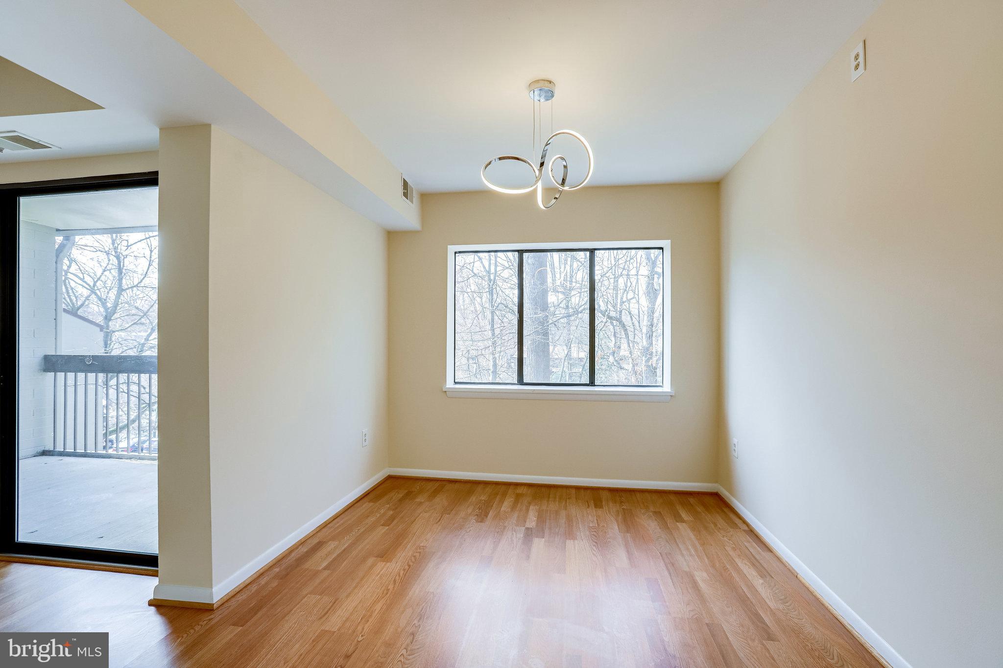 2212 Springwood Drive, Unit 206 Reston, VA 20191 - Photo 15 of 46 a view of a room with wooden floor and window