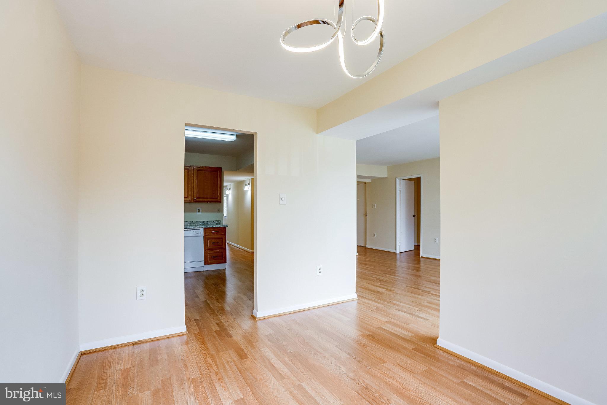 2212 Springwood Drive, Unit 206 Reston, VA 20191 - Photo 16 of 46 wooden floor in an empty room with a window