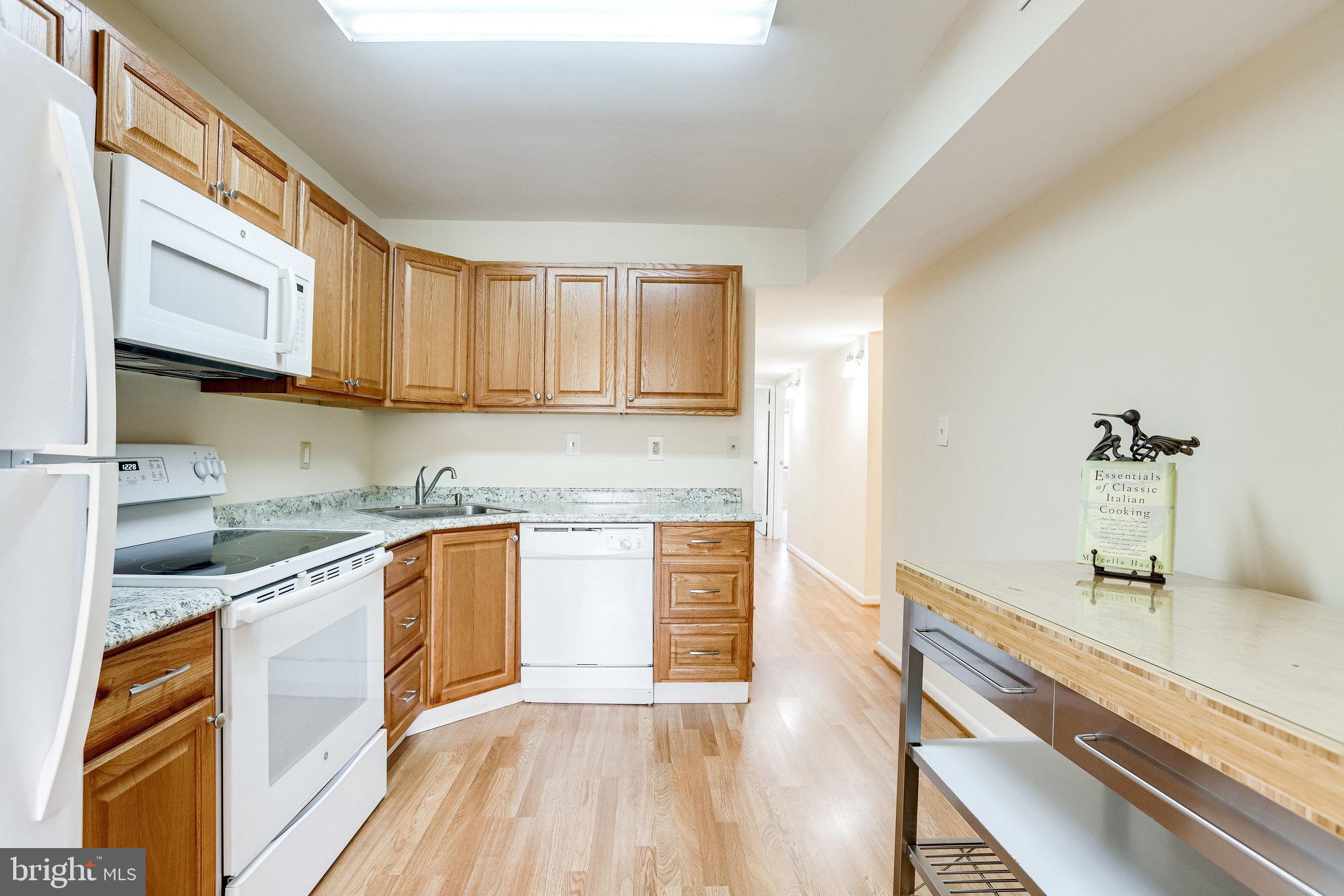 2212 Springwood Drive, Unit 206 Reston, VA 20191 - Photo 18 of 46 a kitchen with stainless steel appliances granite countertop a sink and cabinets