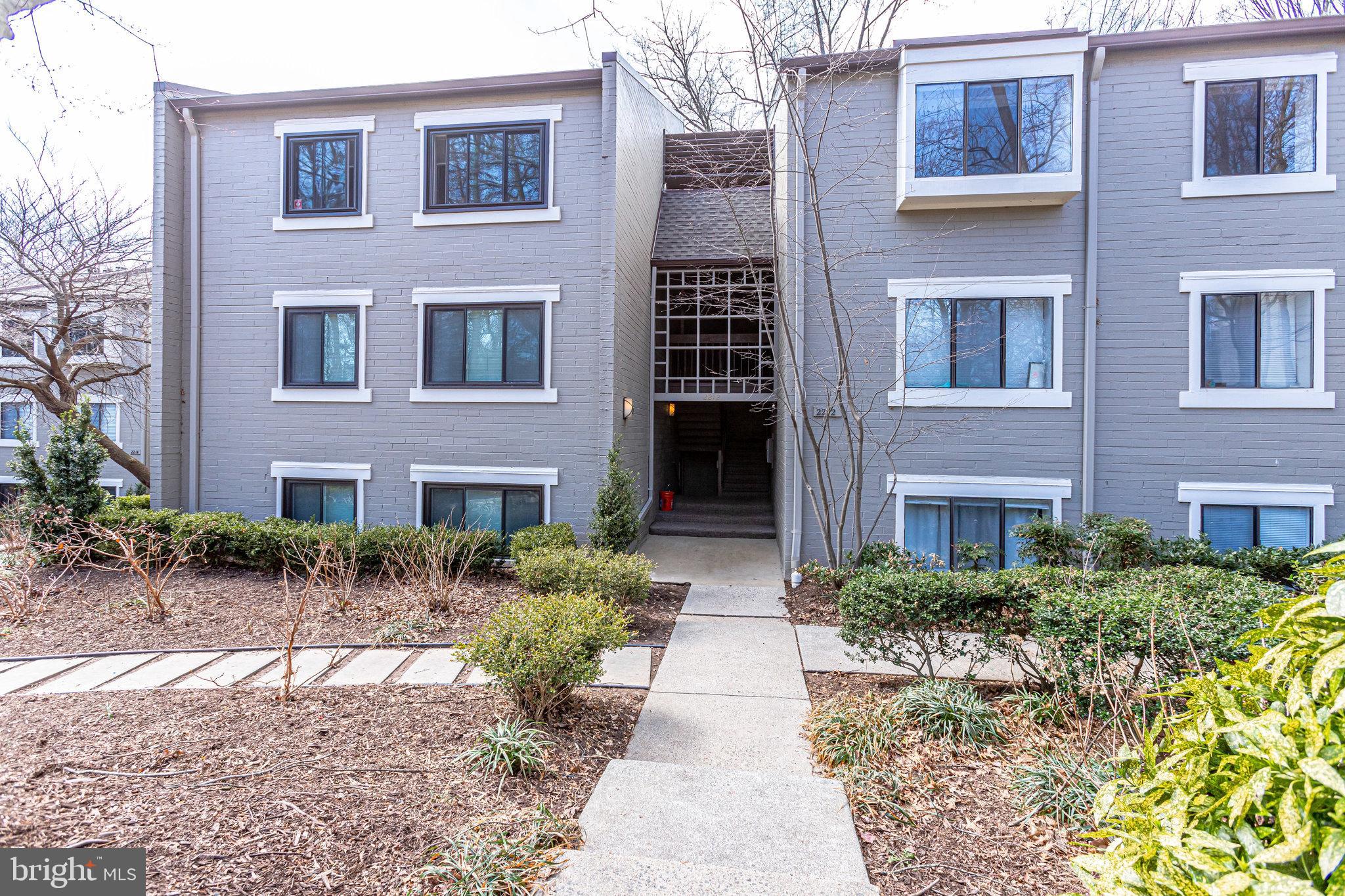 2212 Springwood Drive, Unit 206 Reston, VA 20191 - Photo 2 of 46 a view of a brick building next to a yard