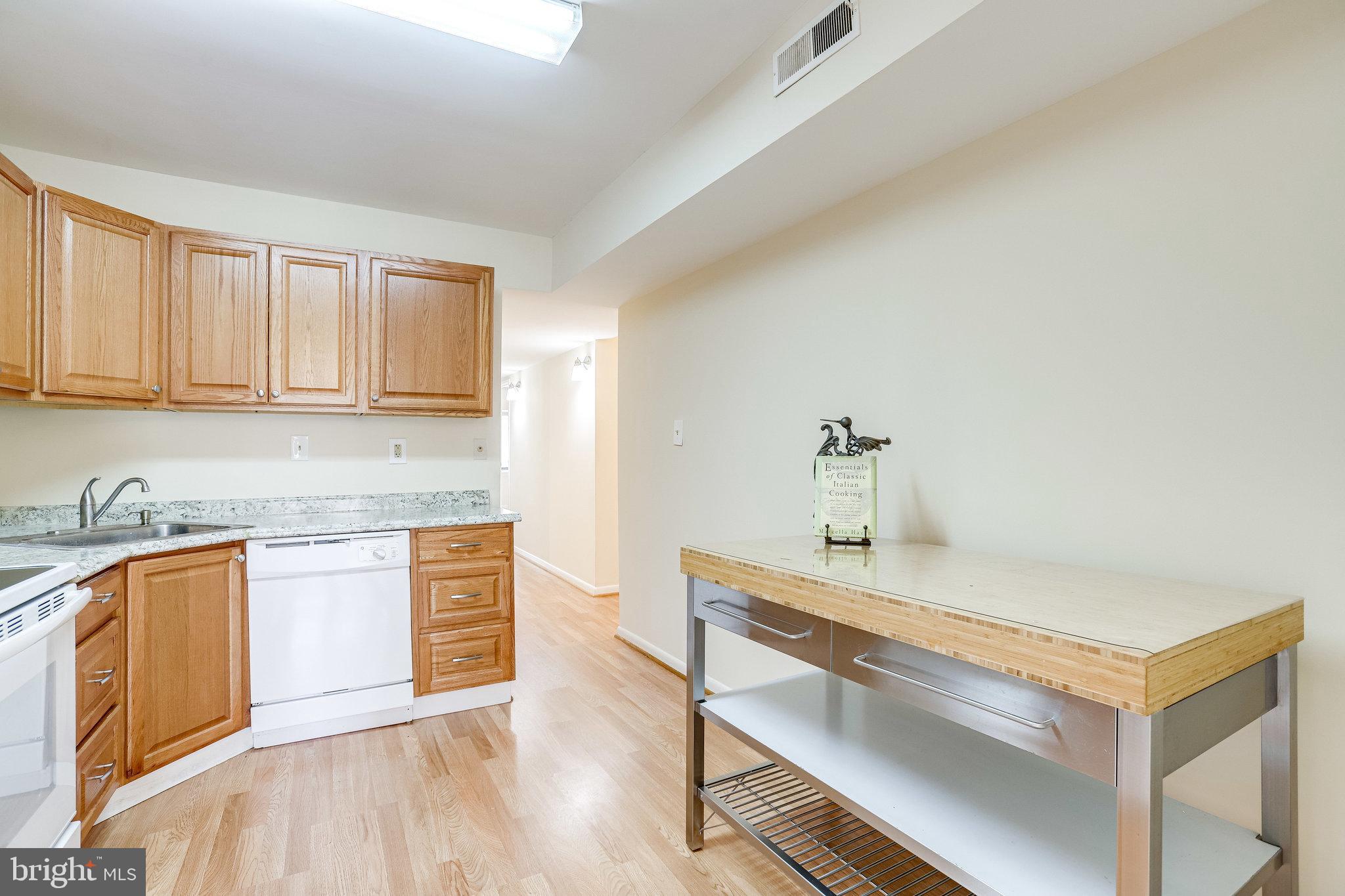 2212 Springwood Drive, Unit 206 Reston, VA 20191 - Photo 22 of 46 a kitchen with a sink cabinets and wooden floor