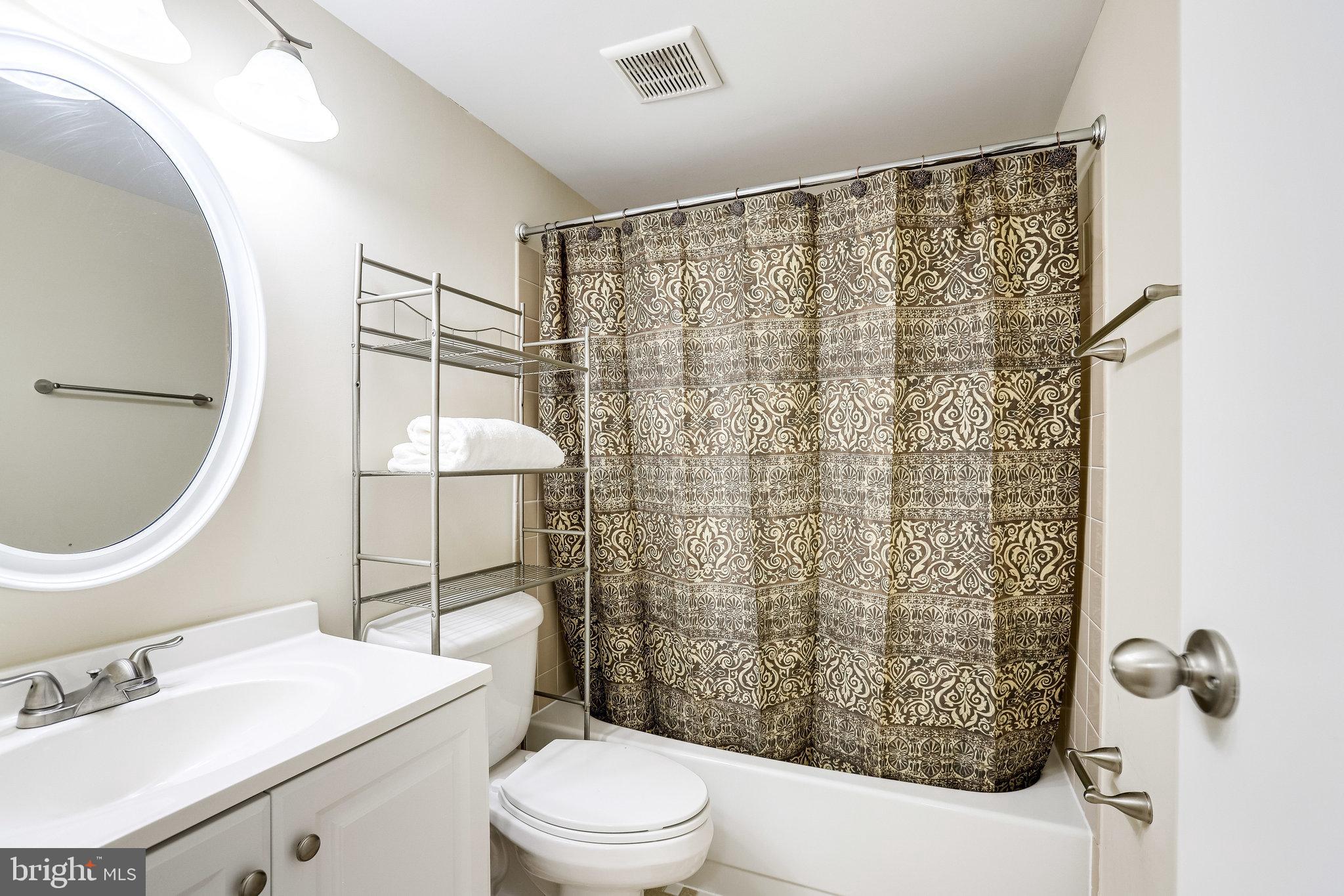 2212 Springwood Drive, Unit 206 Reston, VA 20191 - Photo 33 of 46 a bathroom with a sink toilet and shower