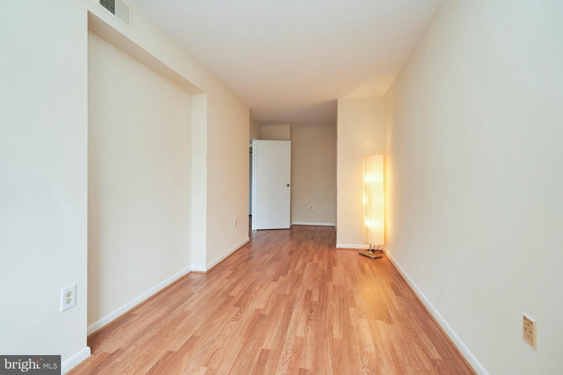 2212 Springwood Drive, Unit 206 Reston, VA 20191 - Photo 35 of 46 a view of a room with wooden floor and bench