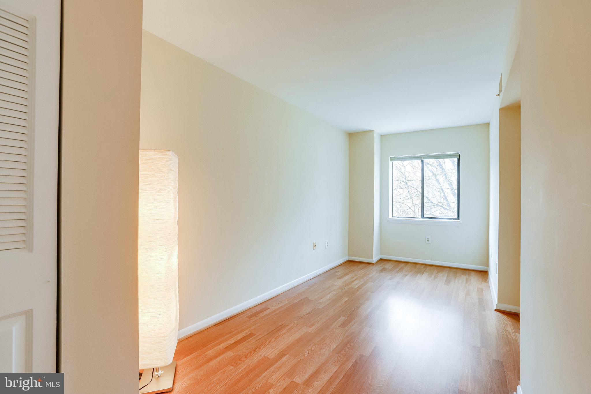 2212 Springwood Drive, Unit 206 Reston, VA 20191 - Photo 36 of 46 a view of an empty room with wooden floor and a window