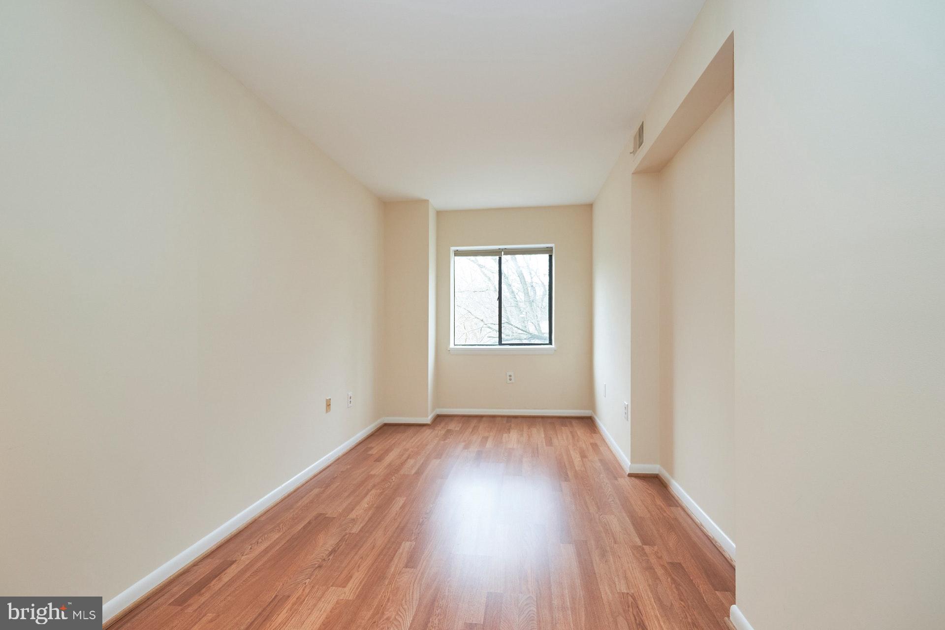 2212 Springwood Drive, Unit 206 Reston, VA 20191 - Photo 37 of 46 a view of an empty room with wooden floor and window