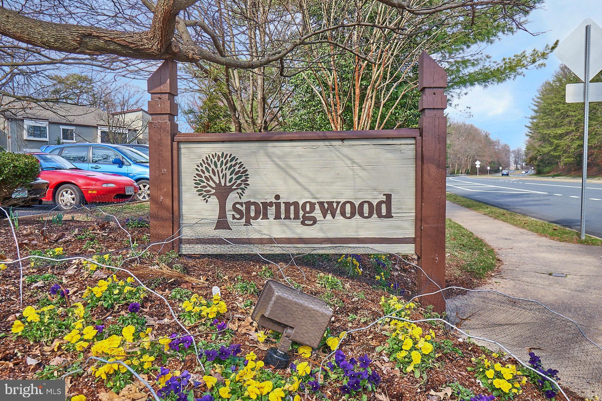 2212 Springwood Drive, Unit 206 Reston, VA 20191 - Photo 46 of 46 a sign that is in front of flowers