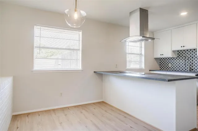 a view of kitchen island with wooden floor