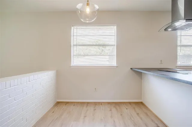 a kitchen with a stove a sink and a window