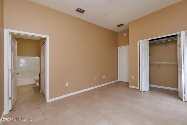 a view of an empty room with a bathroom