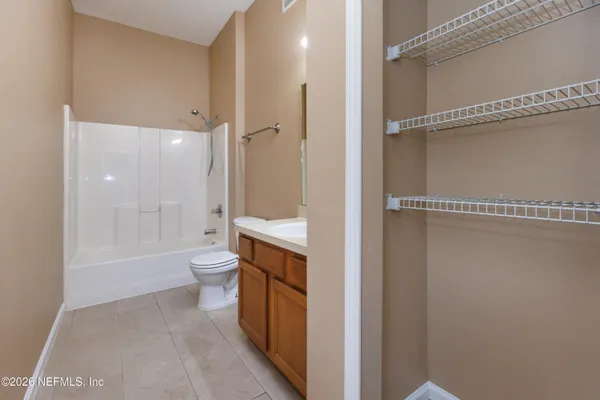 a bathroom with a toilet a sink and shower