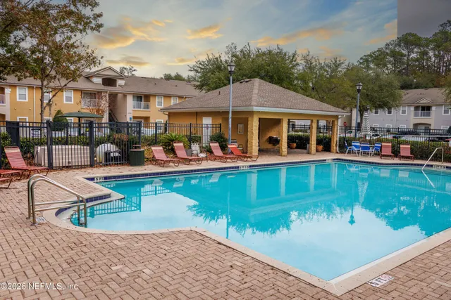 a view of a brick house with many windows