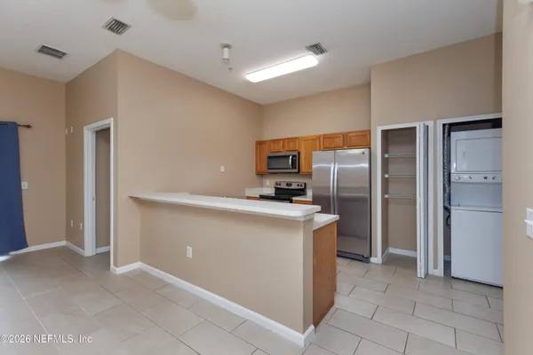 a kitchen with stainless steel appliances a refrigerator and a stove