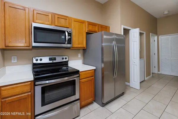 a kitchen with stainless steel appliances a refrigerator microwave and sink