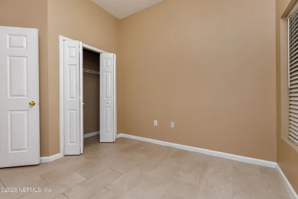 an empty room with closet area
