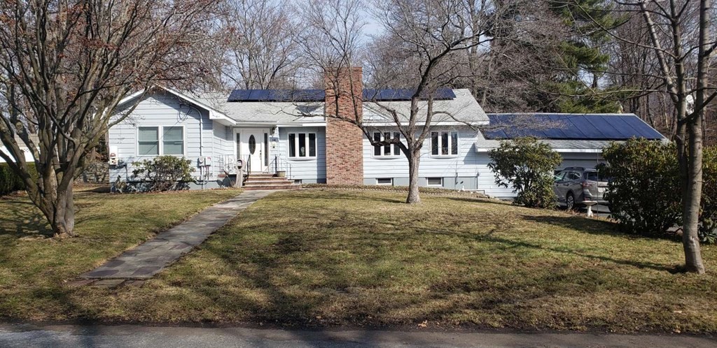 a front view of a house with a yard