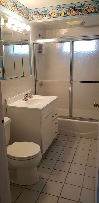 18 Davis Street Woburn, MA 01801 - Photo 11 of 20 a bathroom with a sink a toilet and mirror