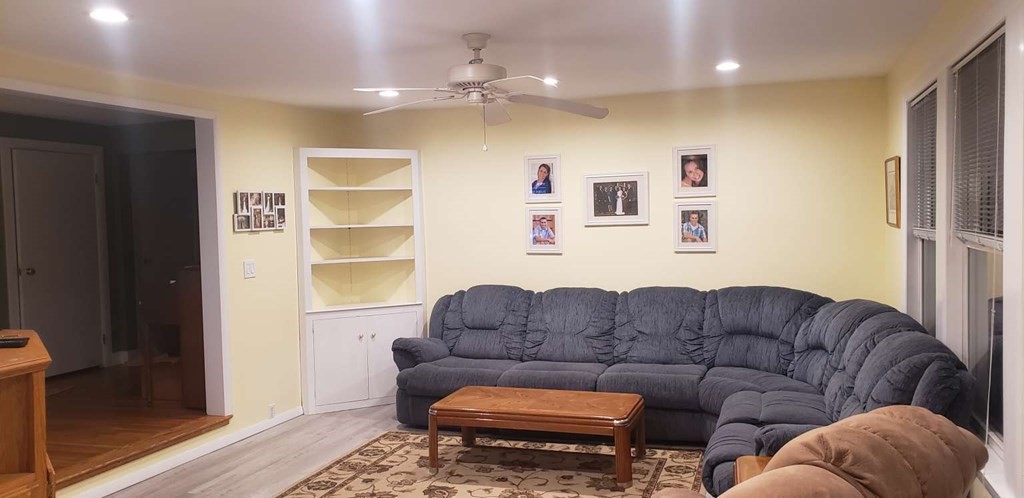 18 Davis Street Woburn, MA 01801 - Photo 15 of 20 a living room with furniture a ceiling fan and a rug