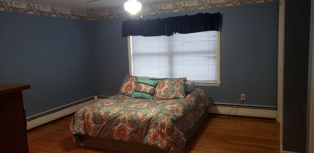 18 Davis Street Woburn, MA 01801 - Photo 5 of 20 a bed sitting in a bedroom next to a window