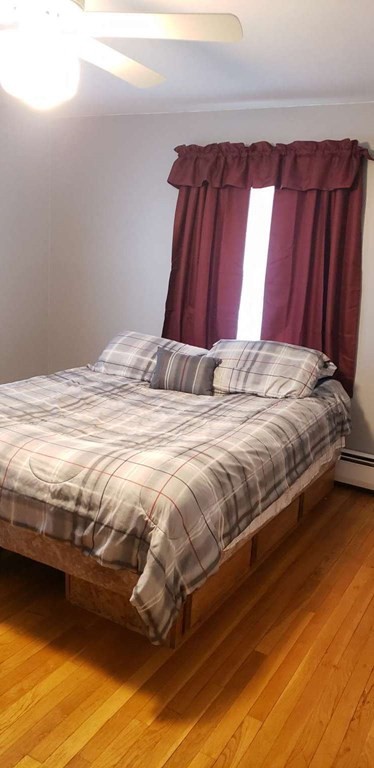 18 Davis Street Woburn, MA 01801 - Photo 9 of 20 a bedroom with a bed and curtain
