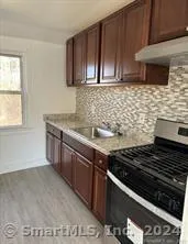 a kitchen with granite countertop a stove and a sink