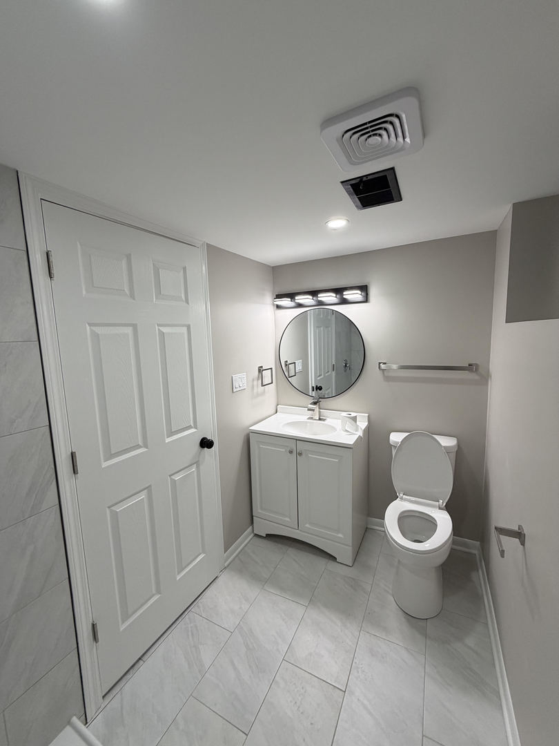 9534 South Yale Avenue Chicago, IL 60628 - Photo 11 of 26 a bathroom with a toilet and a sink