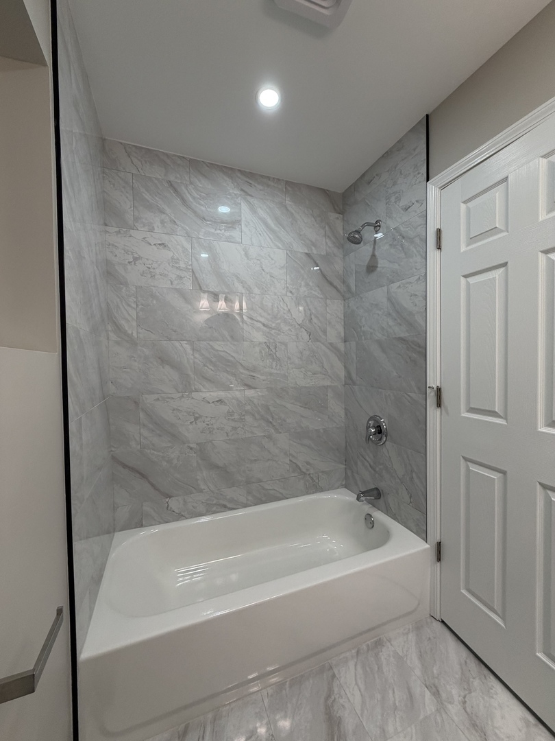 9534 South Yale Avenue Chicago, IL 60628 - Photo 22 of 26 a bathroom with a bathtub and a shower