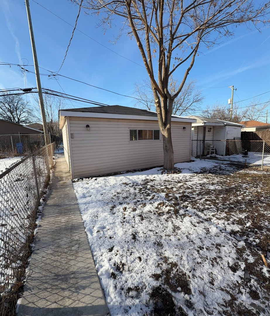 9534 South Yale Avenue Chicago, IL 60628 - Photo 25 of 26 a front view of a house with a yard