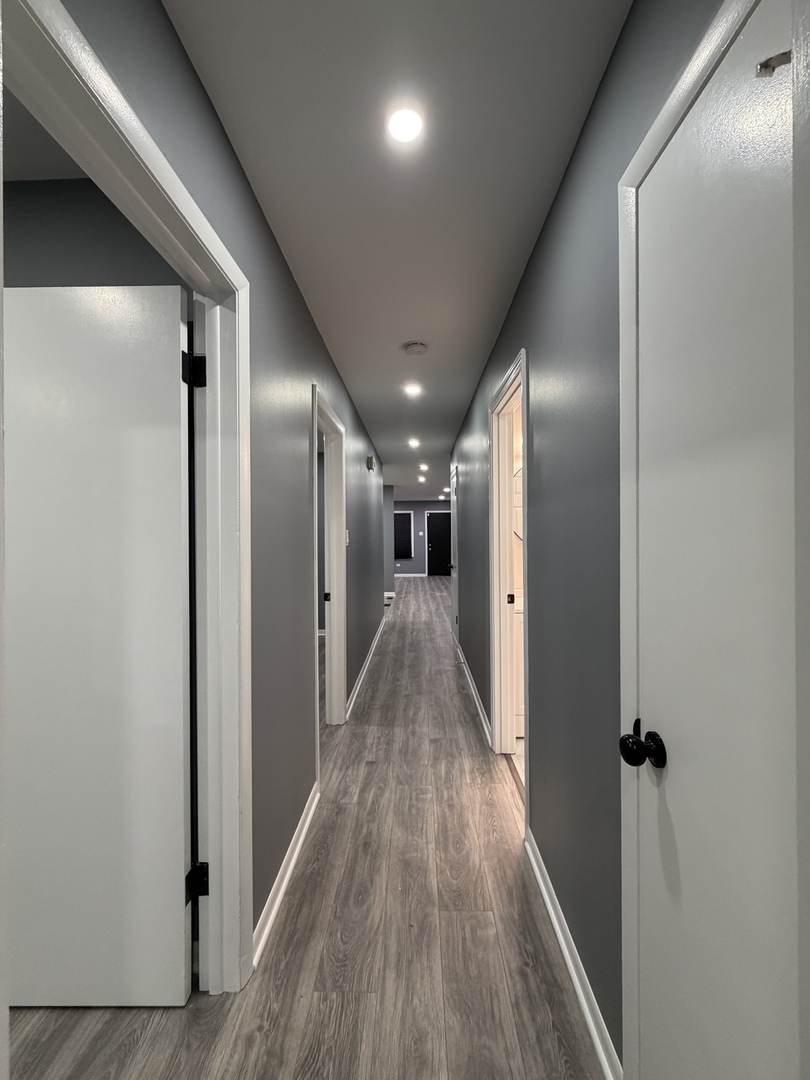 9534 South Yale Avenue Chicago, IL 60628 - Photo 9 of 26 a view of hallway with wooden floor