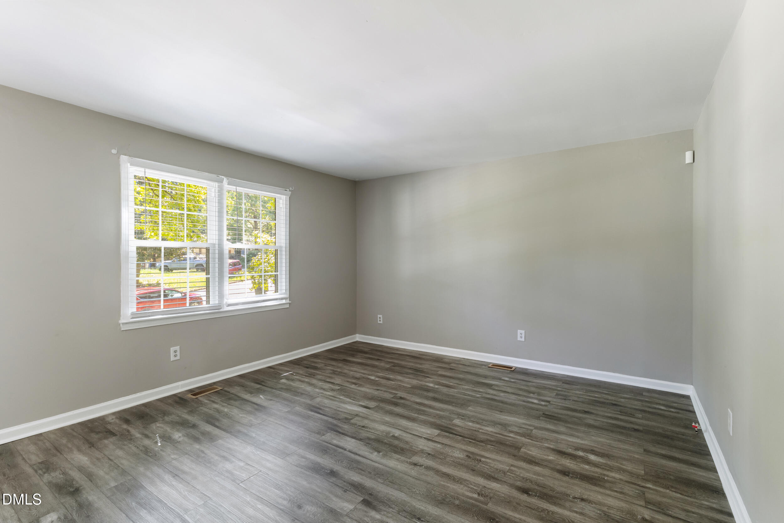2400 Keith Drive Raleigh, NC 27610 - Photo 9 of 35 a view of an empty room with wooden floor and a window