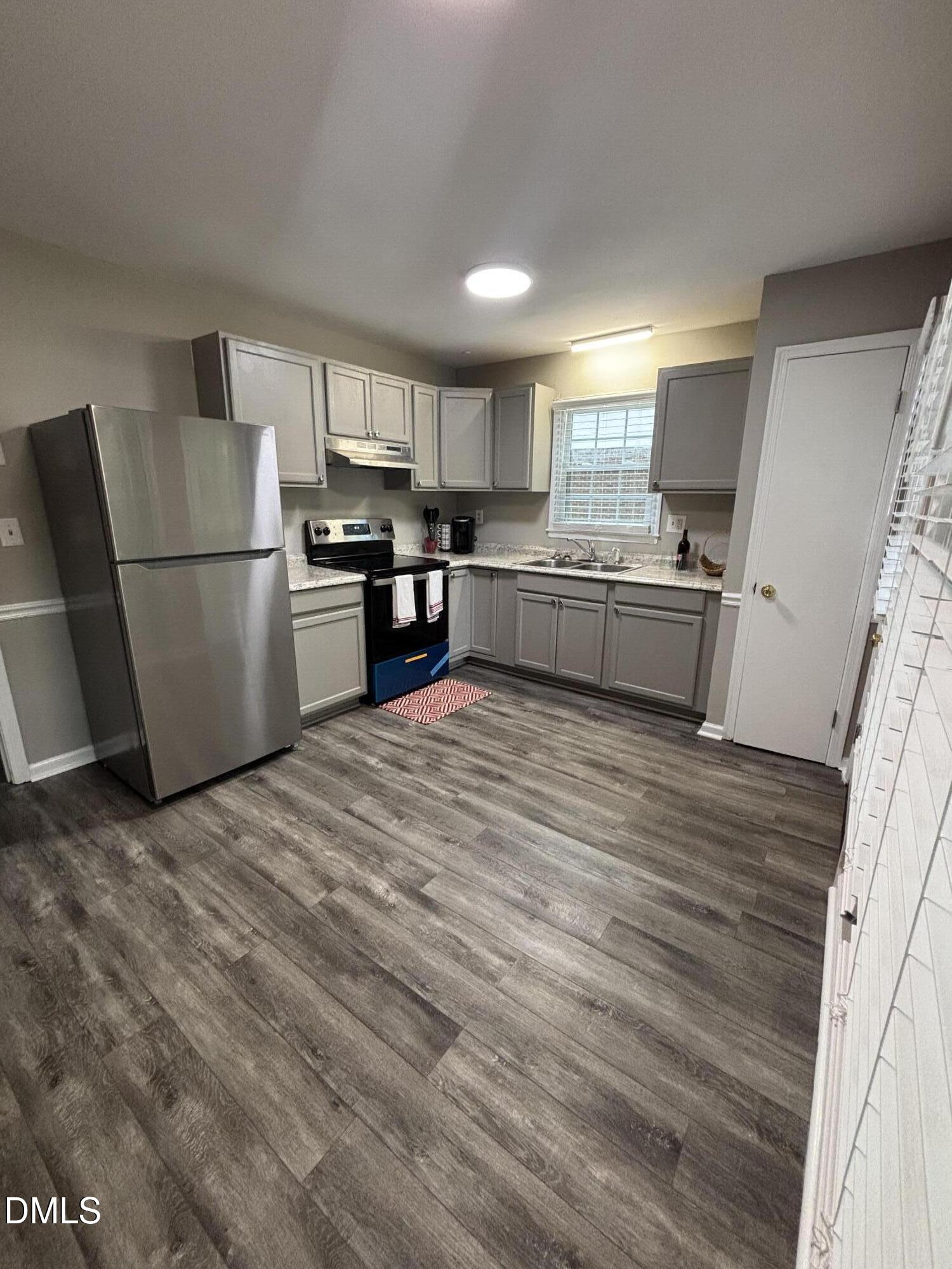 2400 Keith Drive Raleigh, NC 27610 - Photo 11 of 35 a kitchen with a refrigerator and a stove top oven