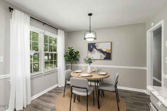a view of a dining room with a table and chairs