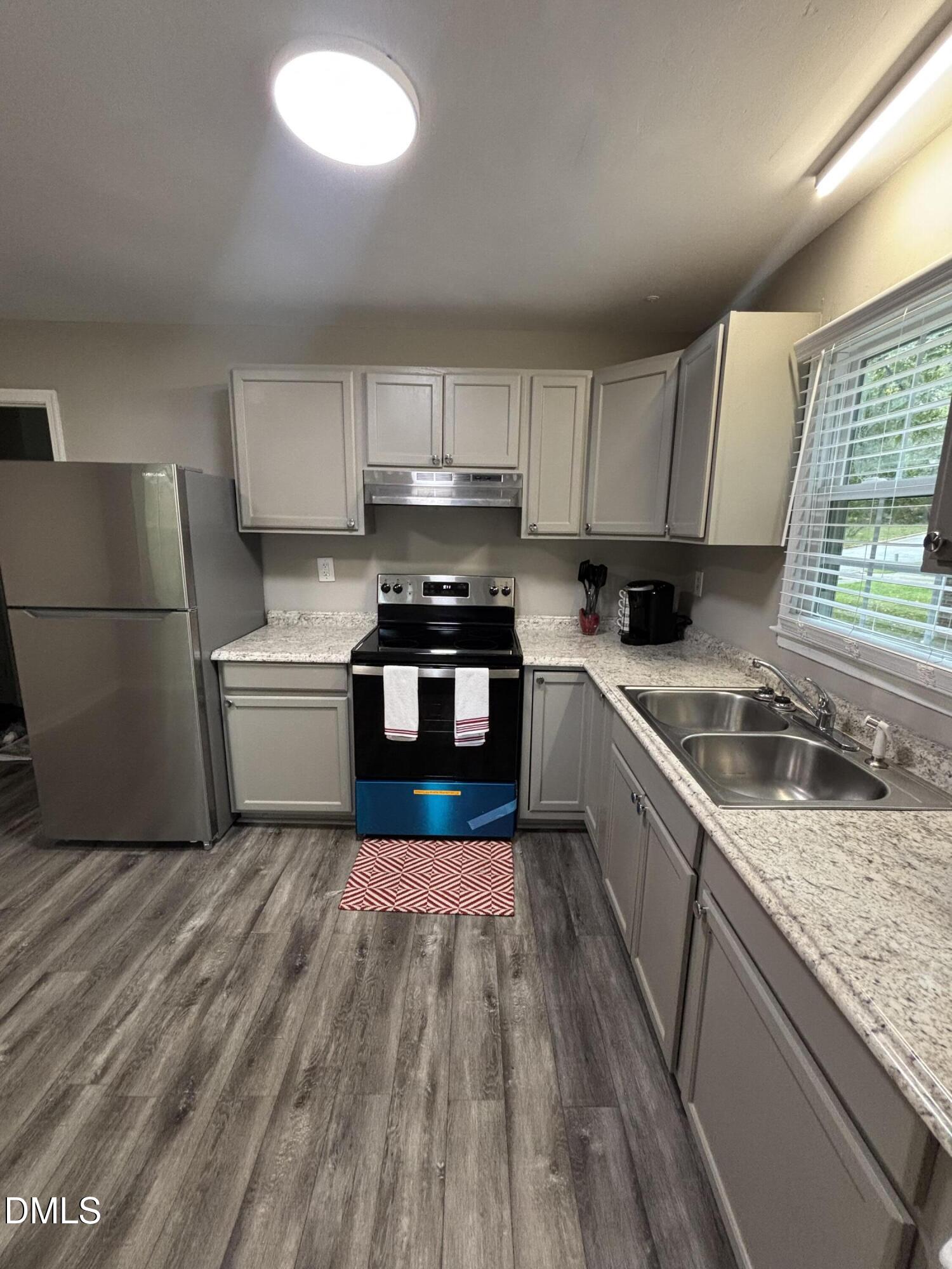 2400 Keith Drive Raleigh, NC 27610 - Photo 14 of 35 a kitchen with a sink a microwave a refrigerator and cabinets