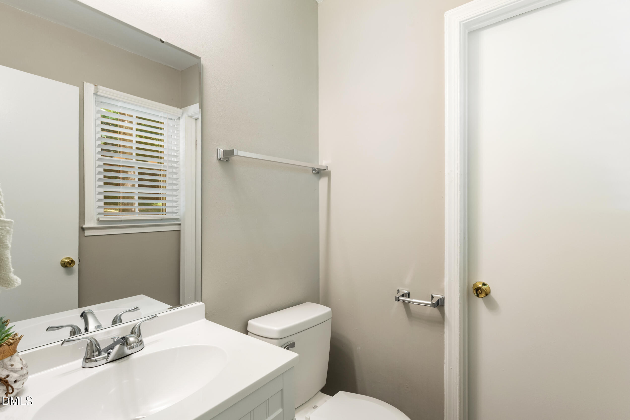 2400 Keith Drive Raleigh, NC 27610 - Photo 22 of 35 a bathroom with a sink a toilet and a mirror