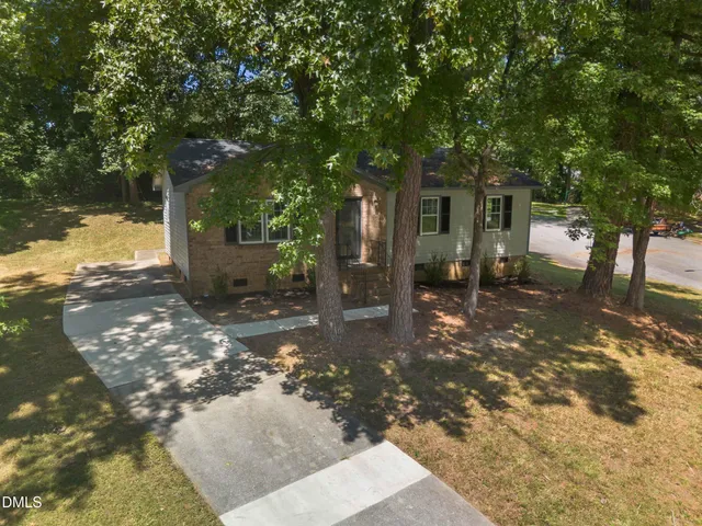 a view of a tree in front of a house