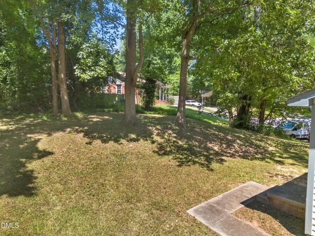 a view of a yard with trees