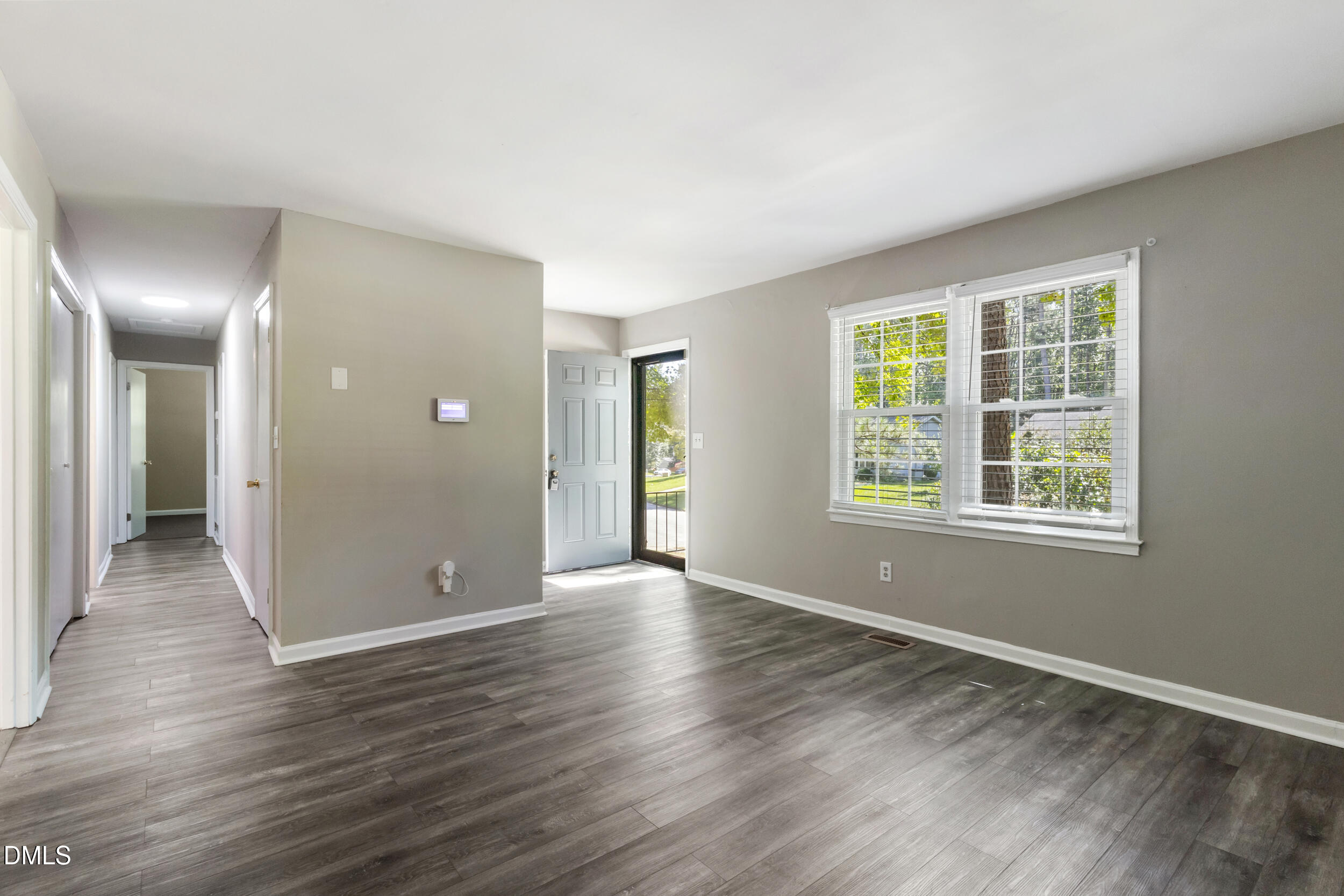 2400 Keith Drive Raleigh, NC 27610 - Photo 5 of 35 a view of an empty room with wooden floor and a window