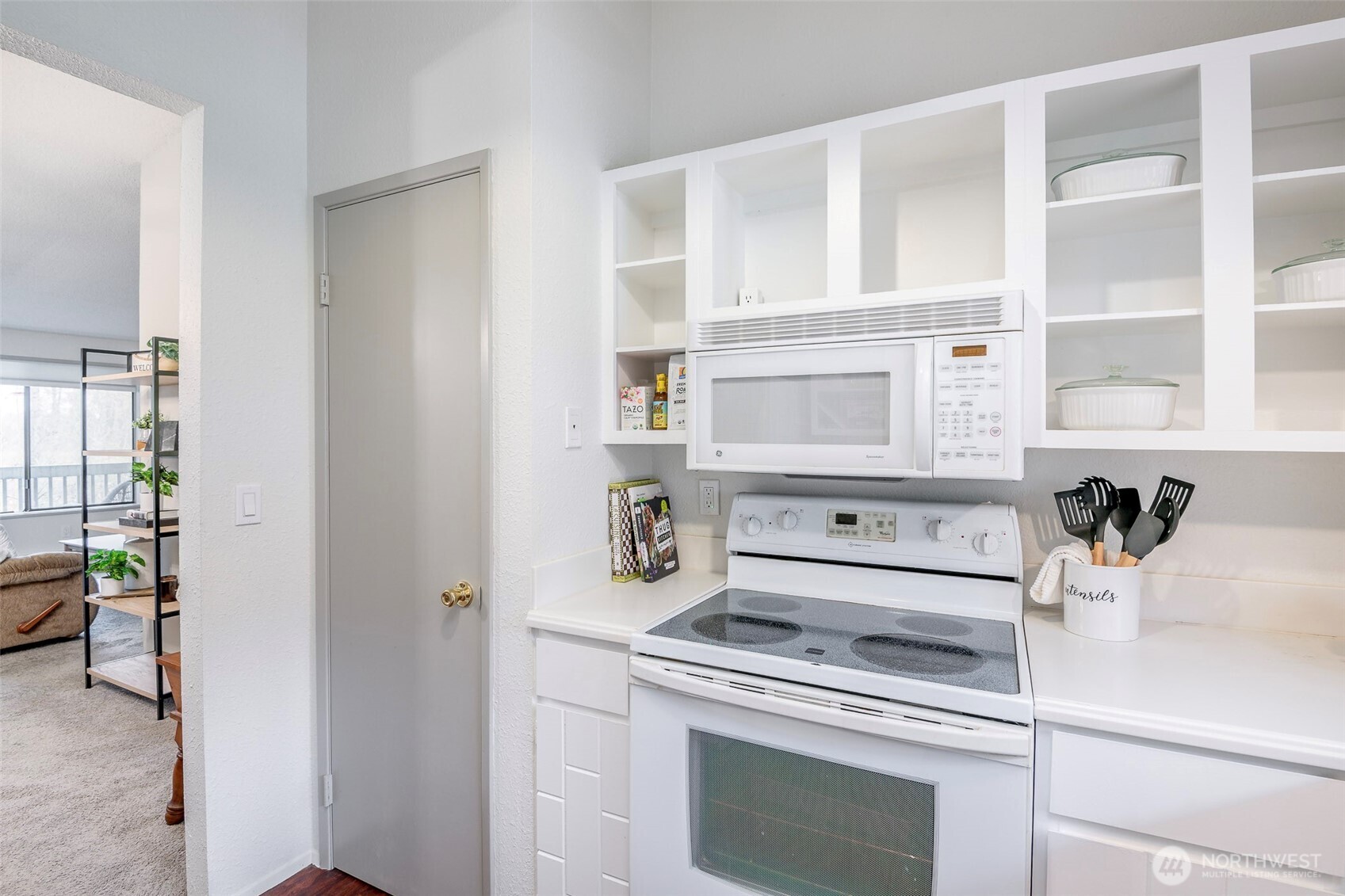 8521 South 259th Street, Unit B15 Kent, WA 98030 - Photo 11 of 24 a kitchen with a stove and a white cabinet