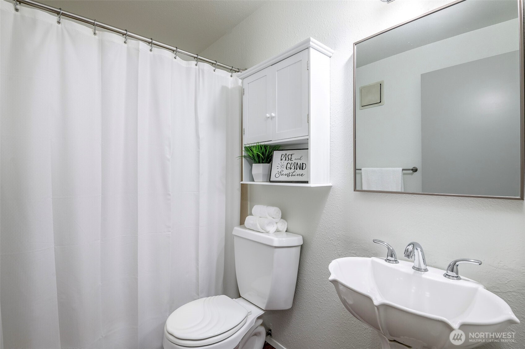 8521 South 259th Street, Unit B15 Kent, WA 98030 - Photo 14 of 24 a bathroom with a sink a toilet and a mirror