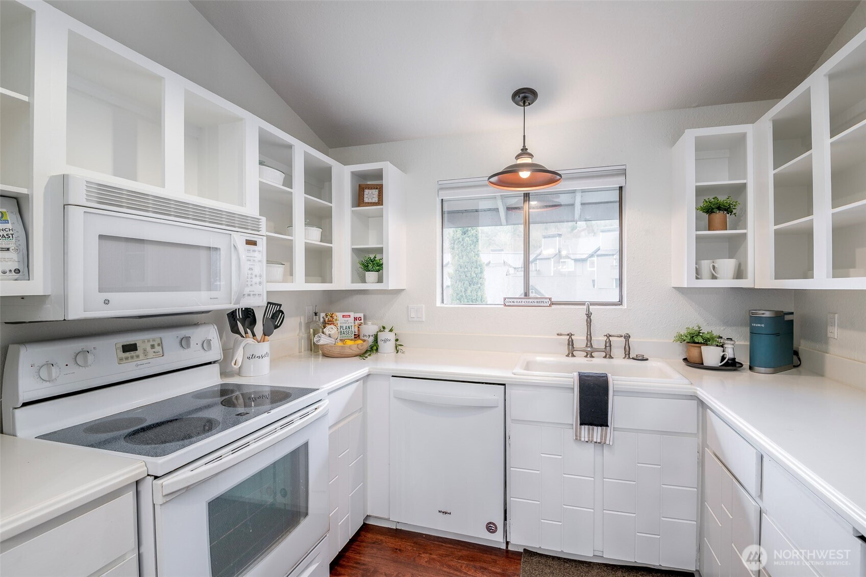8521 South 259th Street, Unit B15 Kent, WA 98030 - Photo 9 of 24 a kitchen that has a lot of cabinets in it and wooden floors