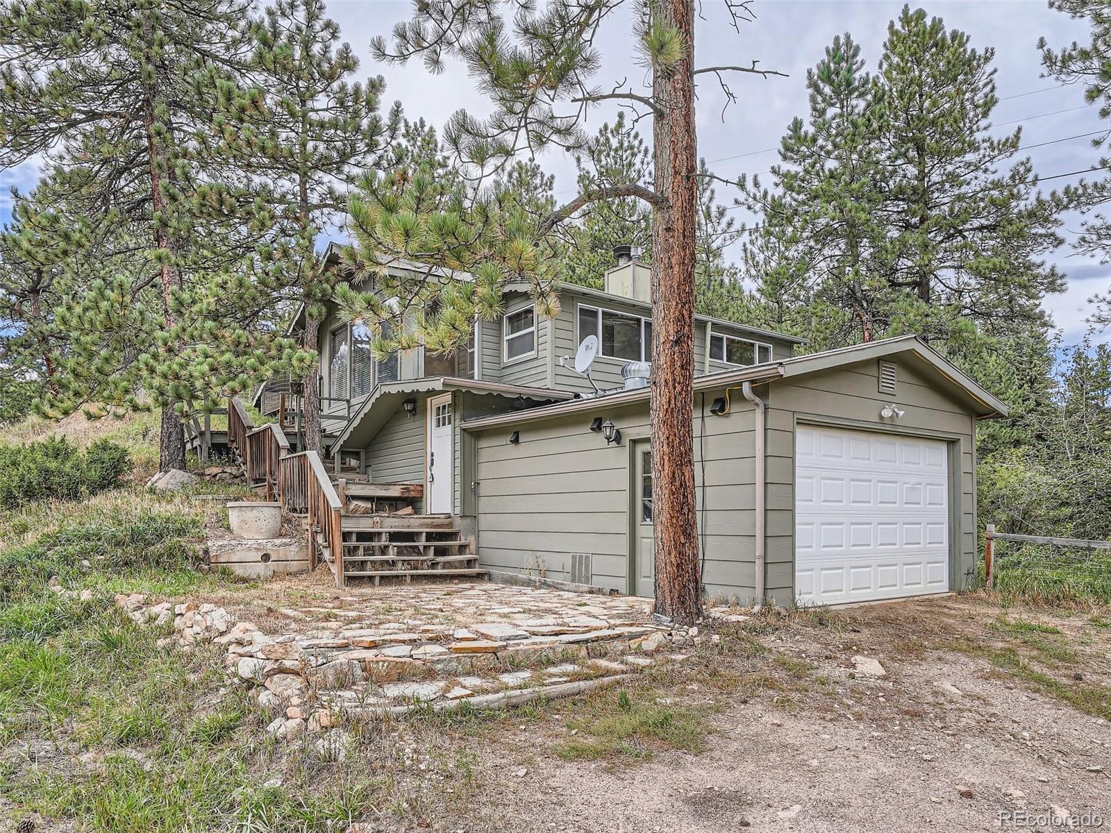 11799 Ranch Elsie Road Golden, CO 80403 - Photo 2 of 28 a front view of a house with a yard