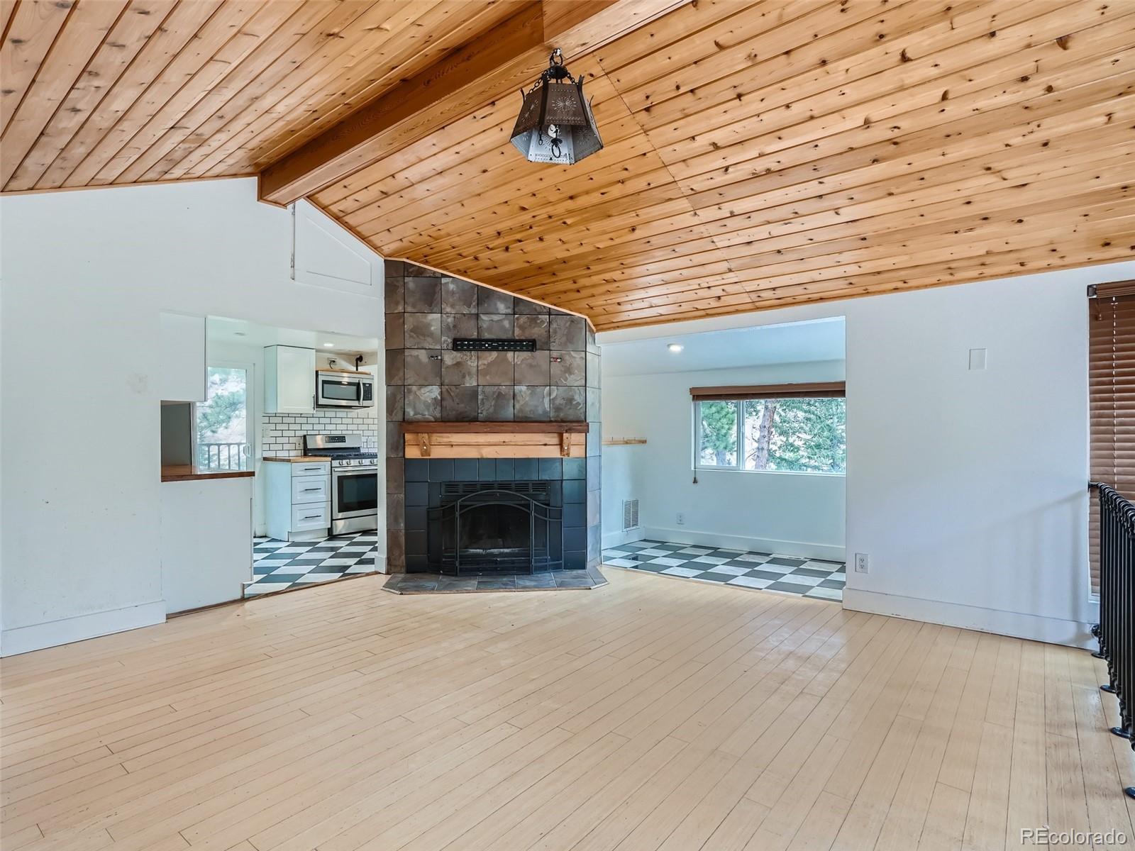 11799 Ranch Elsie Road Golden, CO 80403 - Photo 5 of 28 a view of an empty room with fire place and a window